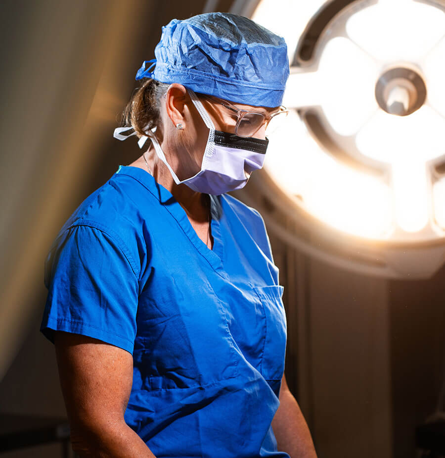 Dr. Flint in the OR in blue scrubs