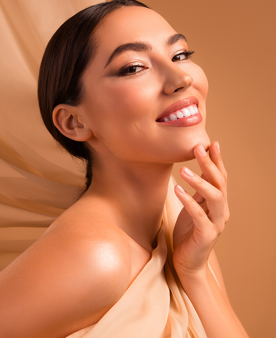 Young woman in tan smiling