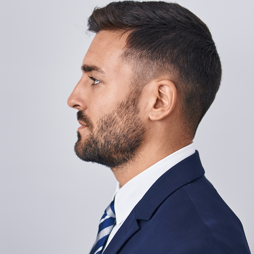 Profile of a young man in a suit