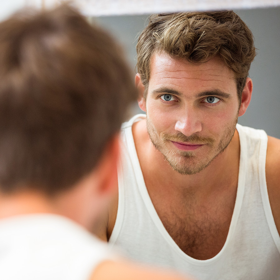 Man looking at himself in the mirror