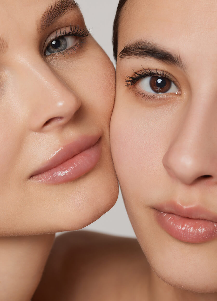 Two women with nice skin and pink lips