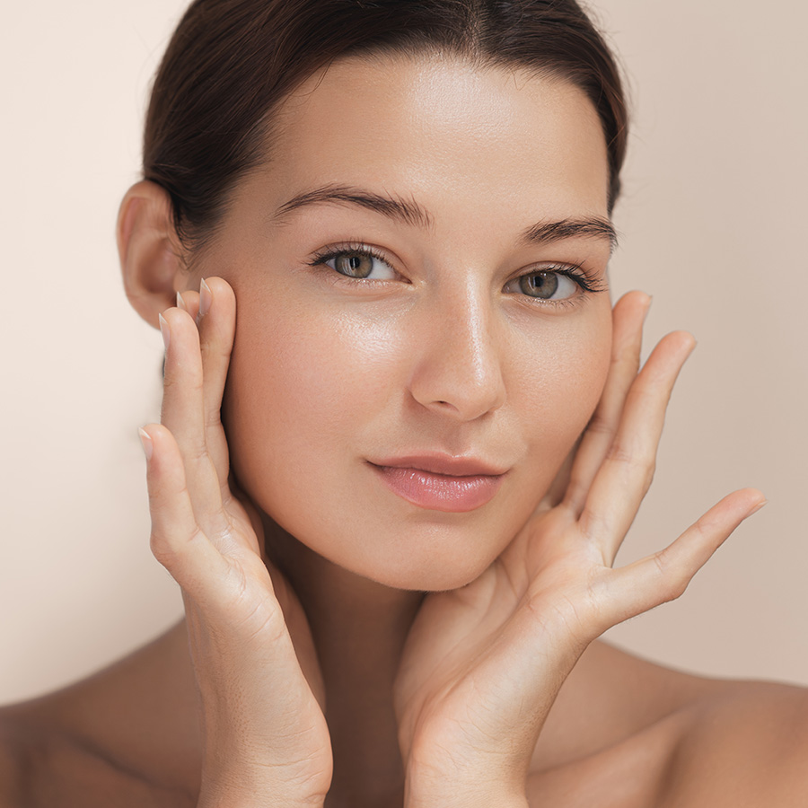 Young woman touching her face