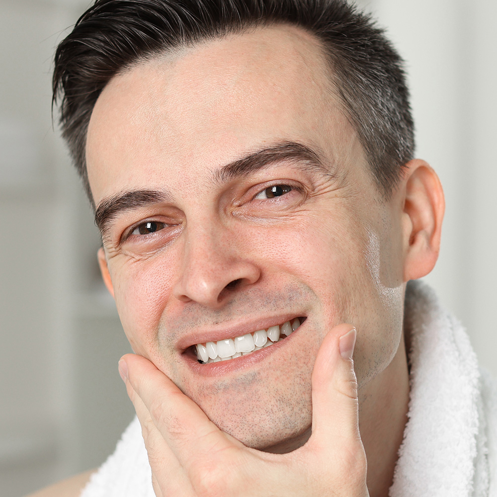 man touching his face