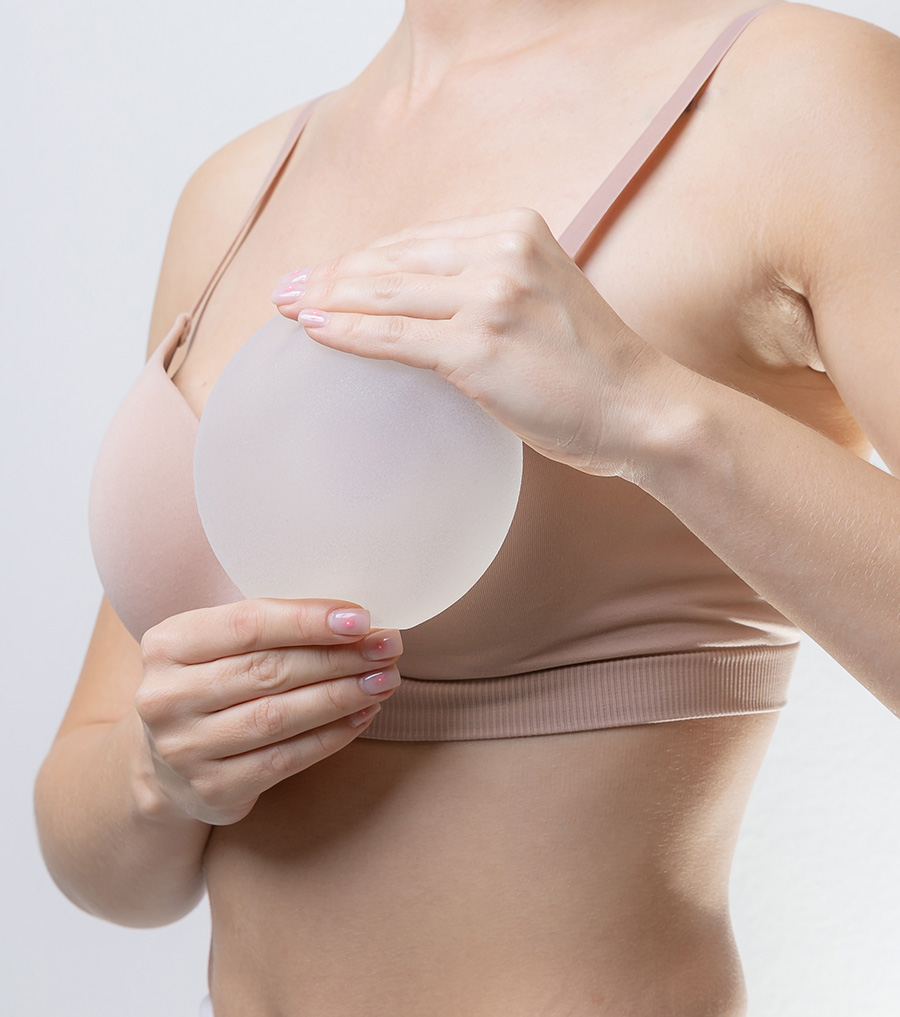 Woman holding a silicone implant